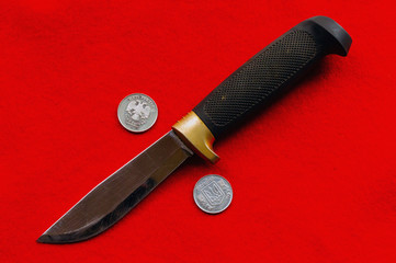 Knife between emblems on coins of Ukraine and Russia. Gap  Relations between countries.