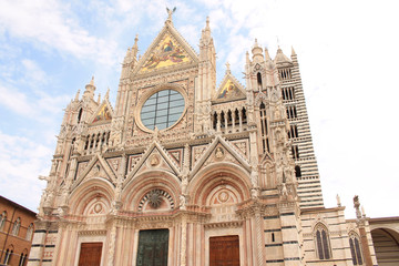 Fototapeta na wymiar The huge majestic cathedral of Saint Mary of the Assumption on the Duomo Square, a medieval church in Siena, Tuscany, Italy
