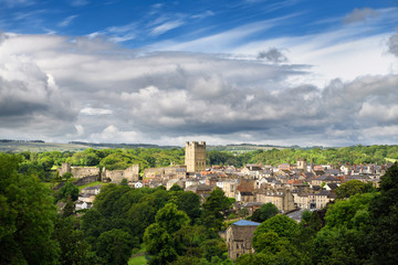Fototapeta na wymiar Historic market town of Richmond in North Yorkshire England with Norman Richmond Castle in sun with cloudy sky