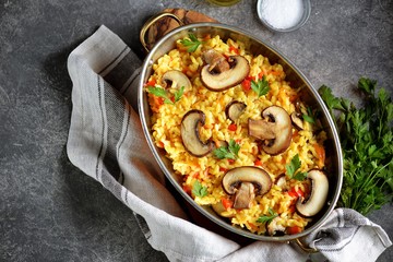 Paella or risotto with mushrooms, bell peppers, carrots, onions, white wine and olive oil. Homemade healthy food.