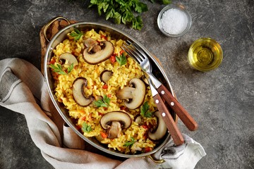Paella or risotto with mushrooms, bell peppers, carrots, onions, white wine and olive oil. Homemade healthy food.