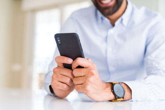Close up of man using smartphone smiling