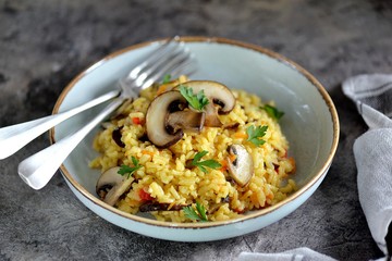 Paella or risotto with mushrooms, bell peppers, carrots, onions, white wine and olive oil. Homemade healthy food.