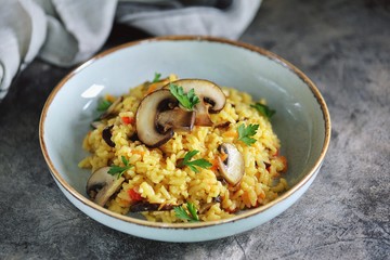 Paella or risotto with mushrooms, bell peppers, carrots, onions, white wine and olive oil. Homemade healthy food.