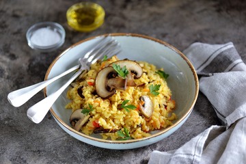 Paella or risotto with mushrooms, bell peppers, carrots, onions, white wine and olive oil. Homemade healthy food.