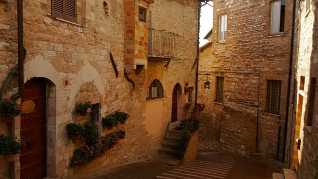 Walking along the picturesque Via Santa Croce, also known as Zu den Deutschen Schwestern von S. Croce, in Assisi, Umbria, Italy