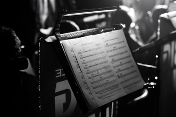 Orchestra music stands. Performance on the stage of a brass symphony orchestra. musician reads...