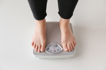 Woman standing on scales. Weight loss concept