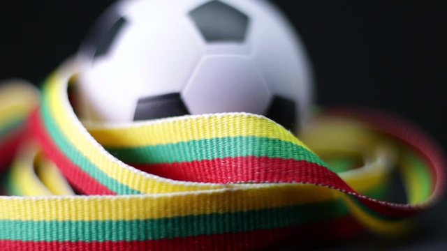 Close-Up Of Small Soccer Ball And Lithuanian Flag Ribbon.