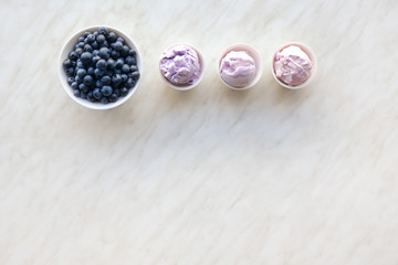 Obraz na płótnie Canvas Bowls with tasty blueberry ice cream on light background