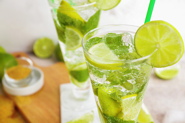 Glass of fresh mojito on table, closeup