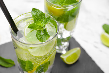 Glass of fresh mojito on table, closeup