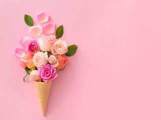 Beautiful rose flowers with wafer cone on color background