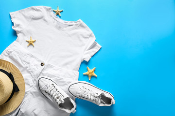 Summer composition with female clothes and accessories on color background