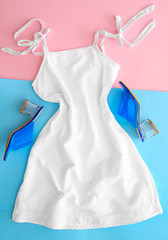 Female dress with shoes on color background