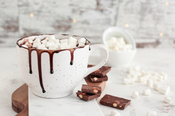 Cup of hot chocolate with marshmallows on table