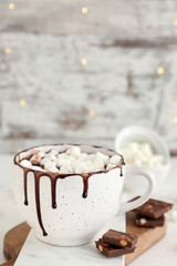 Cup of hot chocolate with marshmallows on table