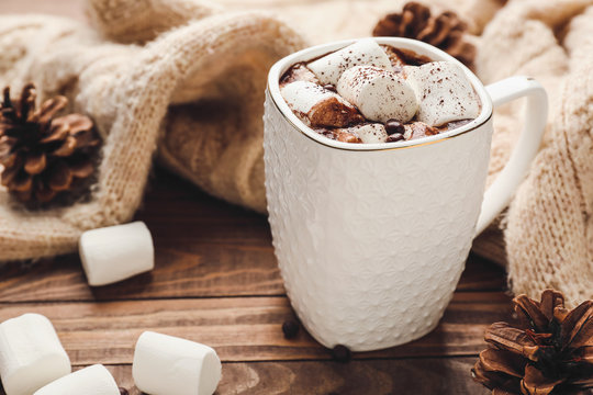 Cup of hot chocolate with marshmallows on wooden table