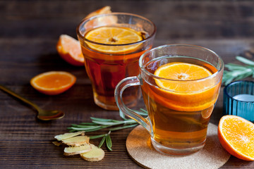 Two cups with hot tea on wood desk, close-up