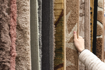 Buyer choosing a new carpet in a store.