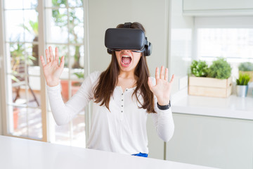 Young woman playing virtual reality game using simulation glasses headset, funny and amazing entertainment