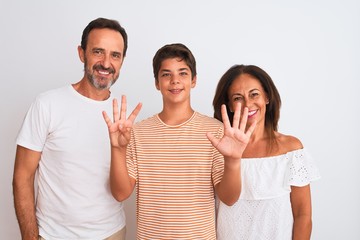 Family of three, mother, father and son standing over white isolated background showing and pointing up with fingers number nine while smiling confident and happy.