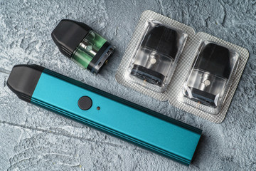 Vape pod system or pod mod with changeable cartridges close up - newest generation of vaping...