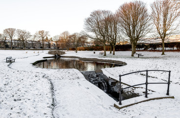 A small artificial pond and river in Westburn park during winter season, Aberdeen, Scotland
