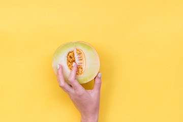 Hand in the melon cut. Melon seeds in a cut. Easy eroticism. Sex concept.