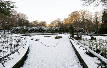 A small scenic garden covered by snow in Victoria Park, Aberdeen, Scotland