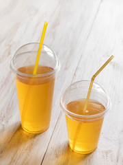 Iced tea in a clear plastic cup with a straw. Kombucha is a drink produced by fermenting tea with symbiotic culture of bacteria.