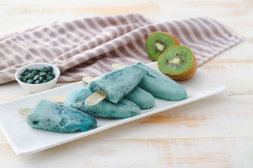 Plate with tasty spirulina ice-cream on table