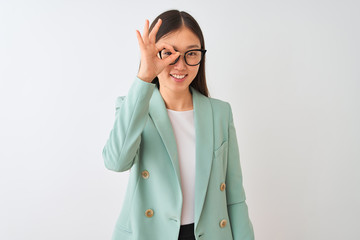Chinese businesswoman wearing elegant jacket and glasses over isolated white background doing ok gesture with hand smiling, eye looking through fingers with happy face.