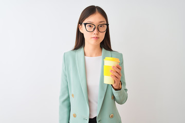 Young chinese woman wearing glasses drinking coffe over isolated white background with a confident expression on smart face thinking serious