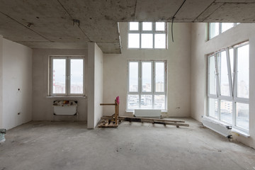 Spacious living room in a new building, with stained-glass windows and a second light