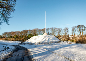 A tall flagpole on top of the Mound fully covered with snow in Duthie park, Aberdeen, Scotlan