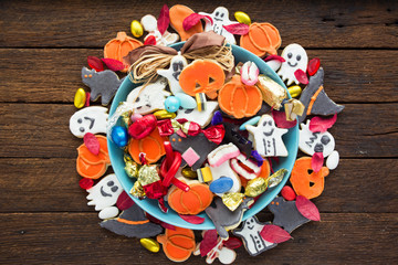 Halloween Jack o Lantern candy bowl with candy and halloween cookies Trick or Treat on old wooden background