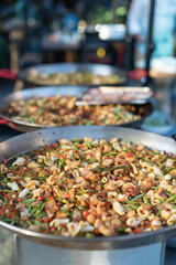 Process of Cooking Spanish Seafood and Vegetables Paella in Traditional Pan