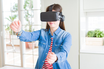 Young asian woman wearing virtual reality glasses smiling and concentrated playing video games of driving a car