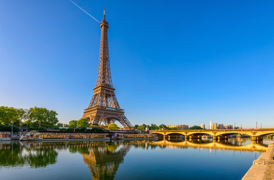 View of Eiffel Tower and river Seine at sunrise in Paris, France. Eiffel Tower is one of the most iconic landmarks of Paris