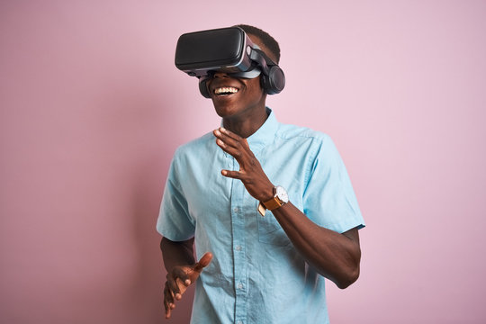 Young african american man playing virtual reality game using goggles