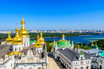 Fototapeta na wymiar View on Dormition Cathedral and Refectory church of the Kiev Pechersk Lavra, river Dnieper and Kiev cityscape