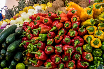 Piles of red peppers and vegetables in a Cuenca market in Ecuador.