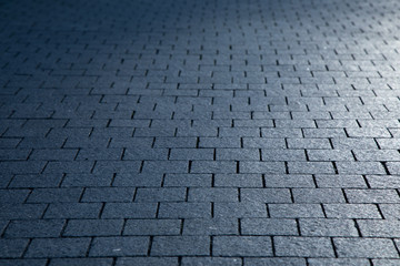 Dark grey granite rectangular pavement close-up texture background