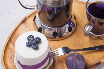 organic Butterfly pea, clitoria or Blue pea flower herbal tea. Thai blue tea. served with lemon, fresh figs and blueberry cake.