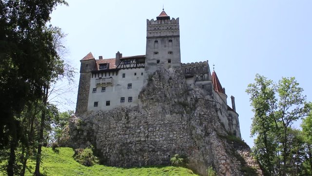 BRAN CASTLE, TRANSYLVANIA, ROMANIA - June 26, 2017: Outside view of the castle that gave rise to the legend of Dracula from the pen of Bram Stoker. HD video