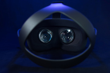 Black virtual reality headset with fresnel lenses and headband.