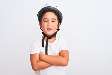 Beautiful kid boy wearing bike security helmet standing over isolated white background happy face smiling with crossed arms looking at the camera. Positive person.