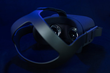 Black virtual reality headset with fresnel lenses and head strap.
