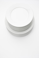 Stack of white plates isolated on white